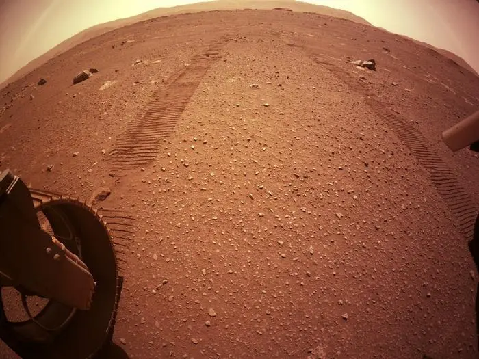 This handout photo released by NASA via NASA's Perseverance Mars Rover Twitter account on March 8, 2021 shows wheel tracks behind the rover as it scouts a spot to drop off the Mars Helicopter, if the area gets certified as a flight zone. - Perseverance was launched on July 30, 2020 and landed on the surface of Mars on February 18 on a mission to search for signs of past life on the Red Planet. (Photo by - / NASA / AFP) / RESTRICTED TO EDITORIAL USE - MANDATORY CREDIT 