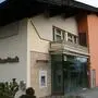 Eine Raiffeisenbank-Filiale in einem gelb-orangen Wohnhaus mit Balkon | Die Bank-Filiale in Drobollach wurde bereits 2018 geschlossen, das Gebäude umfassend renoviert. Den Bankomat gab es noch bis Juni dieses Jahres