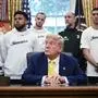 US President Fonald Trump speaks to the press in the Oval Office of the White House as members of Italian soccer club Juventus and coach Igor Tudor (2nd R) pay a visit in Washington, DC, on June 18, 2025. Juventus will play Emirati club Al-Ain in the 2025 FIFA Club World Cup at Washington's Audi Field later in the day. (Photo by Brendan SMIALOWSKI / AFP)