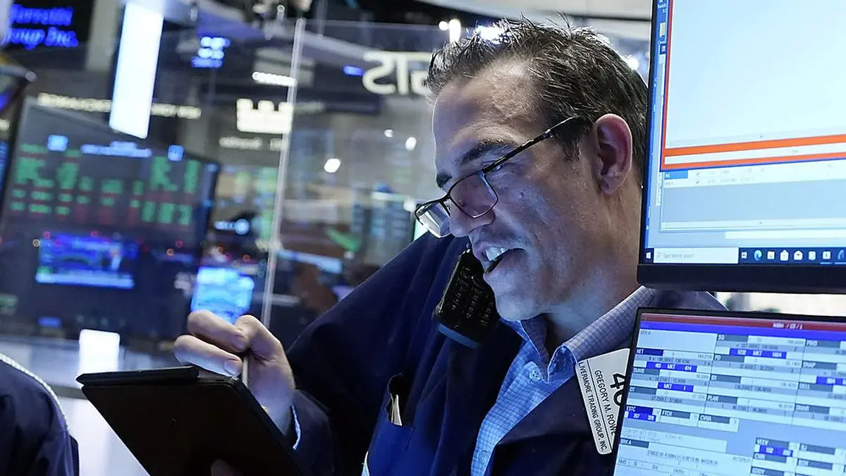 Trader Gregory Rowe works on the floor of the New York Stock Exchange, Thursday, Dec. 2, 2021. Stocks are opening mostly higher on Wall Street Thursday as investors continue to monitor the spread of the new coronavirus variant as well as measures that the U.S. and other governments are taking to restrain it. (AP Photo/Richard Drew)
