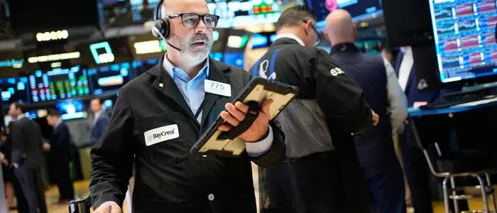 Federico DeMarco works on the floor at the New York Stock Exchange in New York, Wednesday, March 25, 2026. (AP Photo/Seth Wenig)