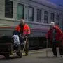 A woman arrived from Kherson leads her dog along a platform for further evacuation into the depths of Russia at the Dzhankoi's railway station in Crimea on October 21, 2022. - The Moscow-installed authorities of the southern Ukrainian Kherson region said on October 20, 2022 that around 15,000 people have been pulled from the territory that Russia claims to have annexed in the face of a Ukrainian advance. (Photo by STRINGER / AFP)