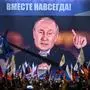 Russian President Vladimir Putin is seen on a screen set at Red Square as he addresses a rally and a concert marking the annexation of four regions of Ukraine Russian troops occupy - Lugansk, Donetsk, Kherson and Zaporizhzhia, in central Moscow on September 30, 2022. (Photo by Alexander NEMENOV / AFP)