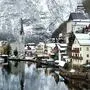 Winter scenic view of village of Hallstatt in the Austrian Alps. Famous postcard view of Hallstatt   xkwx hallstatt snow austria village europe sky famous christmas mountain lake foggy destination scene frozen landscape dramatic view tourist alpine clouds alps architecture austrian blizzard church cold fog see heritage holiday house medieval nature old salzburg salzkammergut scenery scenic town traditional travel unesco vacation water white world cathedral city