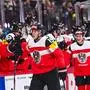 Austria's forward #19 Vinzenz Rohrer (L) celebrates with his teammates after scoring 0-1  during the IIHF Men's Ice Hockey World Championship Group A match between Canada and Austria at the Avicii Arena in Stockholm, on May 15, 2025. (Photo by Jonathan NACKSTRAND / AFP)