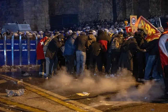 CORRECTION / Protesters clash with Turkish anti riot police as they use tear gas and water cannons during a demonstration following the arrest of Istanbul's mayor, in Istanbul on March 21, 2025. Thousands have rallied in Istanbul for a third night of demonstrations in support of its arrested mayor Ekrem Imamoglu -- the incumbent president's chief political rival -- who was detained just days before he is expected to be formally named as a candidate in the country's 2028 presidential election. The arrest, over two investigations into graft and 