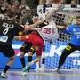 Denmark's Mathias Gidsel, right, challenges for the ball with Germany's Christoph Steinert , centre, and Germany's Johannes Golla during the Handball European Championship semifinal match between Germany and Denmark in Cologne, Germany, Friday, Jan. 26, 2024. (AP Photo/Martin Meissner)
