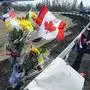A memorial pays tribute to Royal Canadian Mounted Police Constable Heidi Stevenson, a mother of two and a 23-year veteran of the force, along the highway in Shubenacadie, Nova Scotia, on Tuesday, April 21, 2020. Canadian police are investigating at 16 crime scenes after a weekend rampage by a gunman disguised as a police officer left at least 18 dead, including Stevenson, and homes in smoldering ruins in rural communities across Nova Scotia. (Andrew Vaughan/The Canadian Press via AP)