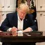 TOPSHOT - This White House handout photo released October 4, 2020 shows US President Donald Trump working in the Presidential Suite at Walter Reed National Military Medical Center in Bethesda, Maryland on October 3, 2020, after testing positive for COVID-19. (Photo by Joyce N. BOGHOSIAN / The White House / AFP) / RESTRICTED TO EDITORIAL USE - MANDATORY CREDIT "AFP PHOTO /THE WHITE HOUSE/JOYCE N. BOGHOSIAN/HANDOUT " - NO MARKETING - NO ADVERTISING CAMPAIGNS - DISTRIBUTED AS A SERVICE TO CLIENTS