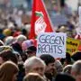 A participant holds up a placard with the lettering 'Against the right wing' during a demonstration against racism and far-right politics in Munich, southern Germany on January 21, 2024. Tens of thousands of people were expected to turn out again on January 21 to protest against the far-right AfD, after it emerged that party members discussed mass deportation plans at a meeting of extremists. (Photo by MICHAELA STACHE / AFP)