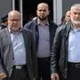 (FILES) Hamas leaders Rawhi Mushtaha (C) and Khalil Al-Hayya (R) walk outside the VIP hall at the Rafah border crossing with Egypt in the southern Gaza Strip on March 15, 2021. The Israeli military said on October 3, 2024, that a strike three months ago killed three senior Hamas leaders in Gaza, including Rawhi Mushtaha, the head of the Hamas government in the Gaza Strip, where the army has been battling the Palestinian militants for nearly a year. (Photo by SAID KHATIB / AFP)