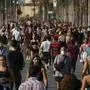 People exercise on a seafront promenade in this photo taken with a telephoto lens in Barcelona, Spain, Saturday, May 2, 2020. Spaniards have filled the streets of the country to do exercise for the first time after seven weeks of confinement in their homes to fight the coronavirus pandemic. People ran, walked, or rode bicycles under a brilliant sunny sky in Barcelona on Saturday, where many flocked to the maritime promenade to get as close as possible to the still off-limits beach. (AP Photo/Emilio Morenatti)