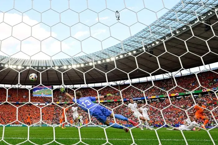 Austria's goalkeeper #13 Patrick Pentz concedes a goal by Netherlands' forward #11 Cody Gakpo during the UEFA Euro 2024 Group D football match between the Netherlands and Austria at the Olympiastadion in Berlin on June 25, 2024. (Photo by JOHN MACDOUGALL / AFP)