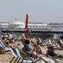 People enjoy the hot weather on the beach as lockdown measures due to the coronavirus outbreak were eased, in Brighton, England, Thursday May 21, 2020. (Gareth Fuller/PA via AP)