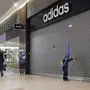 People walk past closed Adidas, Reebok and other shops in a mall in St. Petersburg, Russia, Thursday, March 24, 2022. (AP Photo)