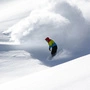 Snowboarder in fine white powder snow