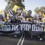 Relatives and supporters of hostages held by Hamas take part in a protest demanding their immediate release and calling for the end of the war in the Gaza Strip as they march on a road near the Israeli-Gaza border, in southern Israel, Wednesday, Aug. 20, 2025. (AP Photo/Maya Levin)