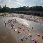 31.07.2018, Bayern, Mnchen: Badende sitzen auf den Kiesbnken in der Isar und genie§en die Sonne. Foto: Peter Kneffel/dpa +++ dpa-Bildfunk +++