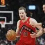Toronto Raptors' Jakob Poeltl (19) drives past Chicago Bulls' Nikola Vucevic (9) during second-half NBA basketball game action in Toronto, Monday, Dec. 16, 2024. (Frank Gunn/The Canadian Press via AP)