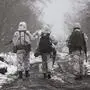 FILE - Ukrainian soldiers walks at the line of separation from pro-Russian rebels near Katerinivka, Donetsk region, Ukraine, Tuesday, Dec 7, 2021. Germany's refusal to join other NATO members in supplying Ukraine with weapons has frustrated allies and prompted some to question Berlin's resolve in standing up to Russia. (AP Photo/Andriy Dubchak)