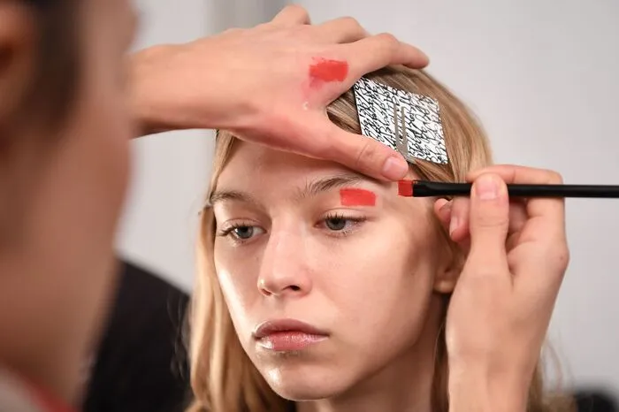 Die Models bekamen farbige Balken über die Augenbrauen gemalt, die sie wie fremde Wesen aus einer anderen Welt wirken ließen.