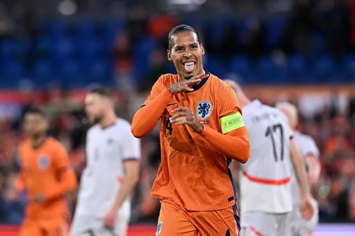 Netherlands' defender #04 Virgil van Dijk (C) celebrates after scoring his teams second goal during the International friendly football match between Netherlands and Iceland at the Feyenoord Stadium, in Rotterdam, on June 10, 2024. (Photo by JOHN THYS / AFP)