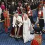 Britain's King Charles III, wearing the Imperial State Crown and the Robe of State, and Britain's Queen Camilla, wearing the George IV State Diadem, process through the Royal Gallery during the State Opening of Parliament at the Houses of Parliament, in London, Tuesday, Nov. 7, 2023. (Justin Tallis/Pool Photo via AP)
