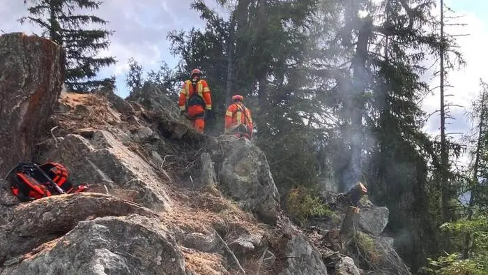 Ein Blitz, der in eine Baumgruppe in dem hochgelegenen und sehr schwer zugänglichen Waldgebiet eingeschlagen hatte, dürfte das Feuer verursacht haben