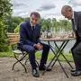 German Chancellor Olaf Scholz, right, and French President Emmanuel Macron sit at a table in the garden of the German government guest house in Meseberg, north of Berlin, Germany, Tuesday, May 28, 2024. (AP Photo/Ebrahim Noroozi, Pool)