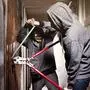 Two teenage burglars breaking in basement cellar with 30 inch bolt cutters