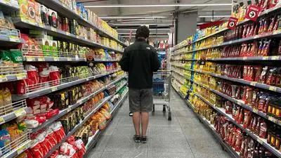 A person buy groceries at a supermarket in Buenos Aires on September 10, 2025. (Photo by Juan MABROMATA / AFP)