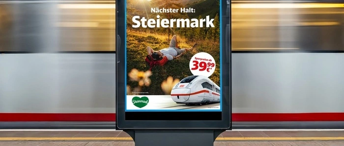 Das Bild zeigt die neue Werbekampagne auf einem Bildschirm an einem Bahnsteig