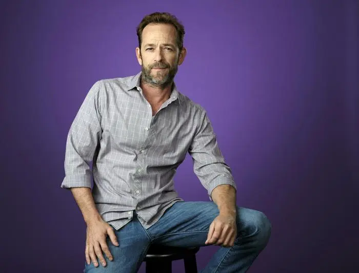 FILE - In this Aug. 6, 2018, file photo, Luke Perry, a cast member in the CW series 'Riverdale,' poses for a portrait during the 2018 Television Critics Association Summer Press Tour in Beverly Hills, Calif. A publicist for the 'Riverdale' and 'Beverly Hills, 90210' star says the actor has been hospitalized. Arnold Robinson said the 52-year-old actor is 'currently under observation' at the hospital. (Photo by Chris Pizzello/Invision/AP, File)