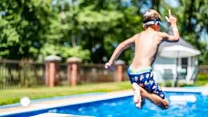 Kind springt in Pool