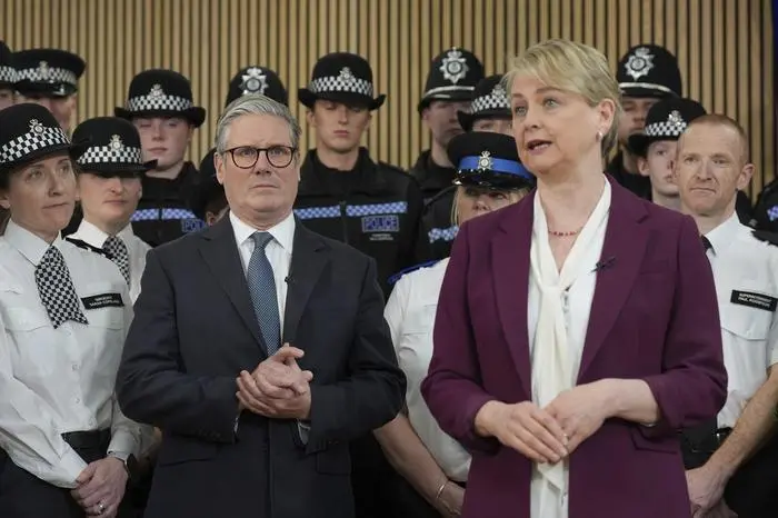 British Home Secretary Yvette Cooper, right, speaks next to British Prime Minister Keir Starmer, during a visit to Cambridgeshire Police Headquarters, Huntingdon, England, Thursday April 10, 2025, as the Labour Government unveils the plan to restore confidence in neighbourhood policing. (Joe Giddens/PA via AP)