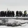 Russia's naval cadets walk along a pier at the Kronshtadt Naval base, outside Saint Petersburg, on January 19, 2022. (Photo by Olga MALTSEVA / AFP)