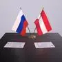 austria  and  Russia  national  flag,  business  meeting  or  diplomacy  deal.  Politics  agreement  3D  illustration. xkwx austria,  russia,  russian,  alliance,  assembly,  background,  business,  business  deal,  business  meeting,  conference,  cooperation,  deal,  delegation,  diplomacy,  diplomatic,  event,  finance,  flagpole,  meeting,  national,  national  flag,  partner,  partnership,  political,  political  background,  political  deal,  politics,  russian  flag,  sign,  table