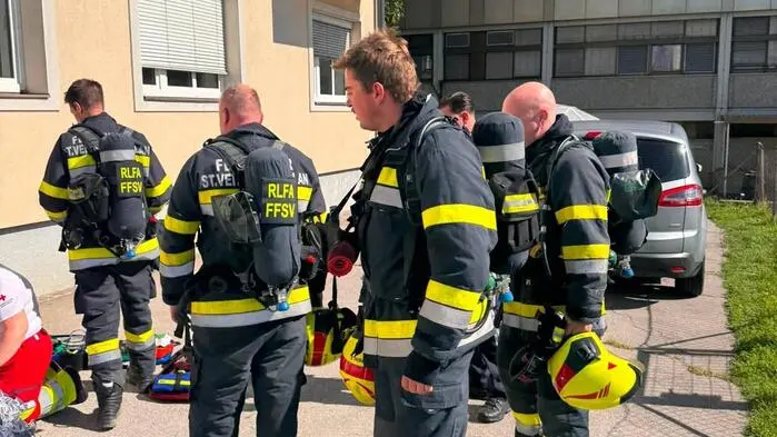Feuerwehrleute vor einem Wohnhaus