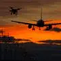 Drone potentially being hit by commercial airplane in sunset silhouettes. Concept of aircraft accident. Thread of collision