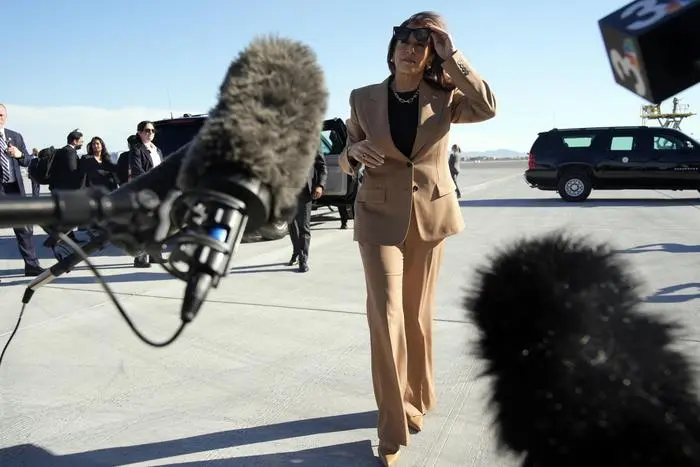 Democratic presidential nominee Vice President Kamala Harris walks over to speak to reporters before she departs Las Vegas from Harry Reid International Airport, Thursday, Oct. 10, 2024, en route to Arizona. (AP Photo/Jacquelyn Martin)