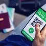 vaccinated person using digital health passport app in mobile phone for travel during covid-19 pandemic
