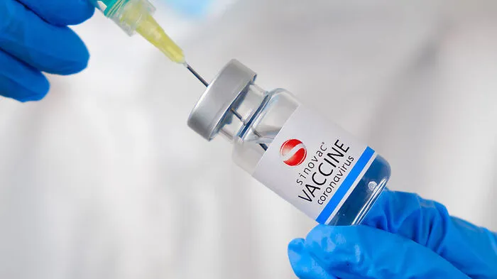 Sinovac coronavirus Vaccine and syringe in the bottle or vial for injection in doctors hands. Covid-19, SARS-Cov-2 prevention, January 2021, San Francisco, USA.