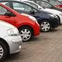 row of different european marques of used cars for retail sale on a motor dealers forecourt all logos removed,sujet, auto, autos, kfz, autohändler, pkw, autoindustrie