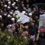 Mourners from the Druze minority march with the coffin for Guevara Ibrahim, 11, one of 12 children and teens killed in a rocket strike on a soccer field, during his funeral in the village of Majdal Shams, in the Israeli-annexed Golan Heights, Monday, July 29, 2024. (AP Photo/Leo Correa)