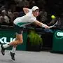 TOPSHOT - Italy's Jannik Sinner plays a backhand return to US' Mackenzie Mcdonald during their men's singles match on day three of the Paris ATP Masters 1000 tennis tournament at the Accor Arena - Palais Omnisports de Paris-Bercy - in Paris on November 1, 2023. (Photo by Dimitar DILKOFF / AFP)