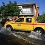 A car from the Civil Protection drives across a flooded street on May 21, 2023 in Conselice, near Ravenna, after deadly floodwaters hit the Emilia-Romagna region. More than 36,000 people have now been forced from their homes by deadly floods in northeast Italy, regional officials said, as rising waters swallowed more houses and fresh landslides isolated hamlets. Violent downpours earlier this week killed 14 people, transforming streets in the cities and towns of the Emilia Romagna region into rivers. (Photo by Andreas SOLARO / AFP)