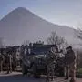 Italian soldiers serving in a NATO-led international peacekeeping mission in Kosovo patrol near a road barricaded with trucks by Serbs in the village of Rudare near the town of Zvecan on December 26, 2022. (Photo by Armend NIMANI / AFP)