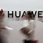 (FILES) In this file photo taken on August 2, 2019 people walk past a Huawei logo during the Consumer Electronics Expo in Beijing. - Huawei was hit February 13, 2020 with new US criminal charges alleging the Chinese tech giant engaged in a "decades-long" effort to steal trade secrets from American companies.A US indictment unsealed in New York alleges Huawei conspired "to misappropriate intellectual property" from six US firms as part of a strategy to grow its global business. (Photo by Fred DUFOUR / AFP)