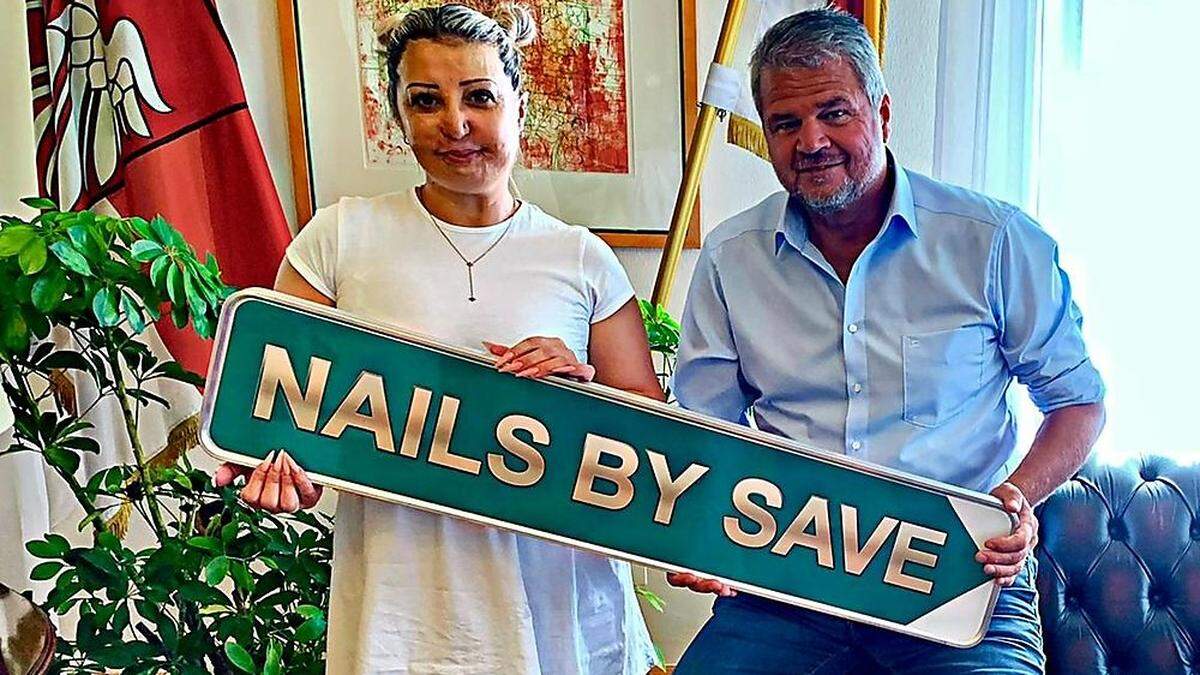 Bürgermeister Gerhard Köfer gratulierte Sevinc „Save“ Plank zum zehnjährigen Jubiläum mit einem Straßenschild