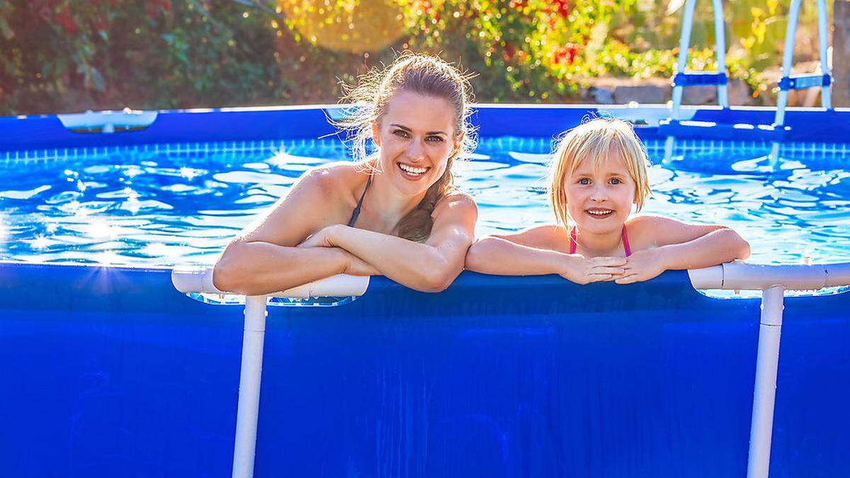 happy active mother and child in swimming pool relaxing